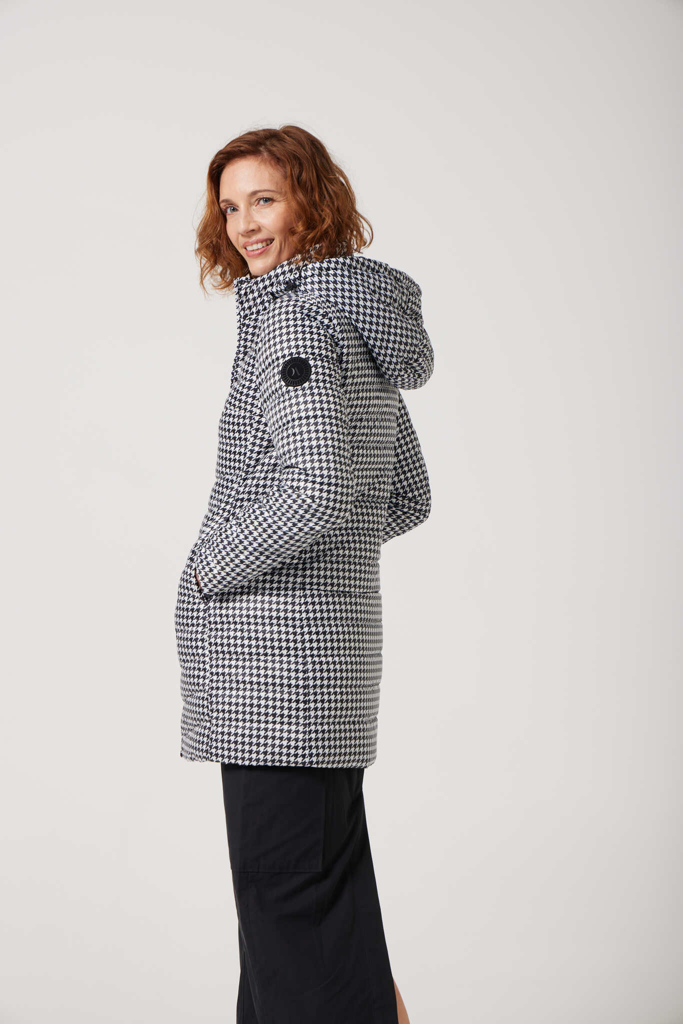Women’s insulated reversible hooded parka in houndstooth print and midnight black, designed for warmth and comfort in South Africa’s winter season — Midnight x Houndstooth Classic Parka™