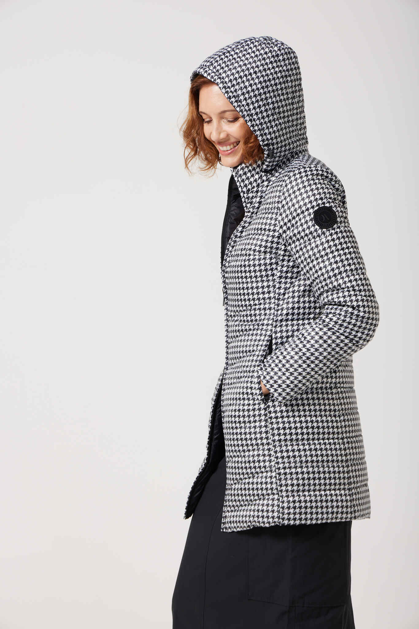 Women’s insulated reversible hooded parka in houndstooth print and midnight black, designed for warmth and comfort in South Africa’s winter season — Midnight x Houndstooth Classic Parka™