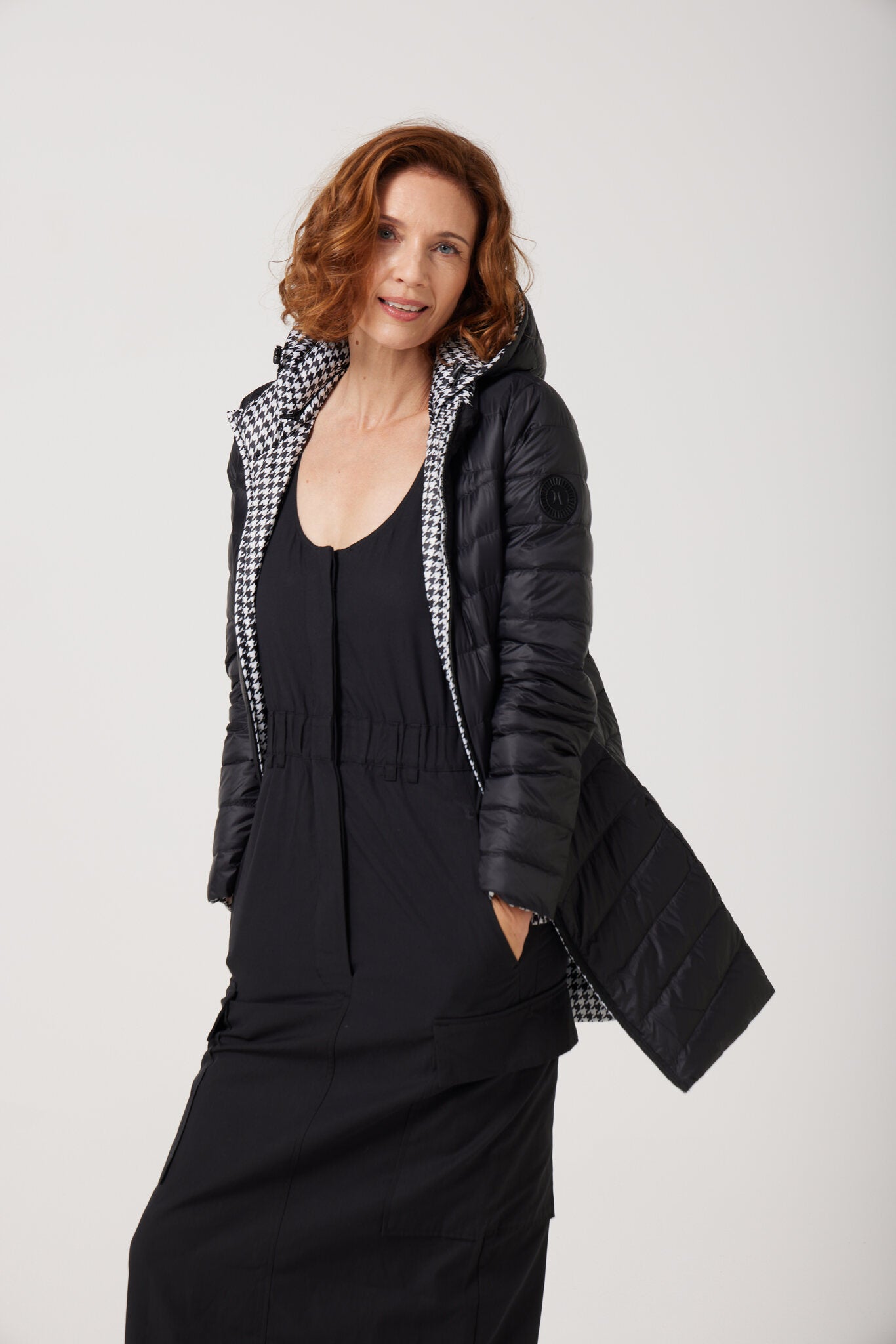 Women’s insulated reversible hooded parka in houndstooth print and midnight black, designed for warmth and comfort in South Africa’s winter season — Midnight x Houndstooth Classic Parka™
