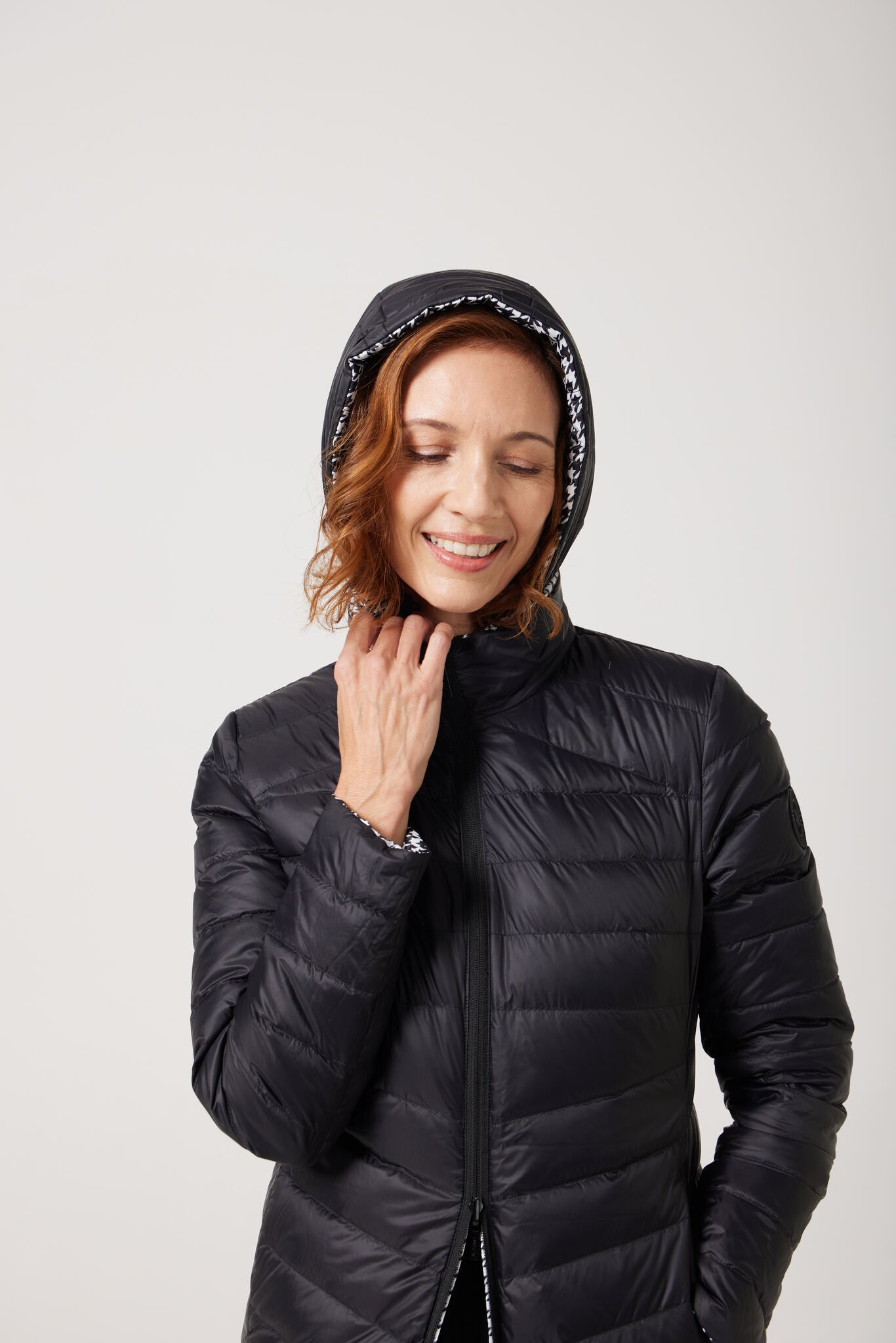 Women’s insulated reversible hooded parka in houndstooth print and midnight black, designed for warmth and comfort in South Africa’s winter season — Midnight x Houndstooth Classic Parka™