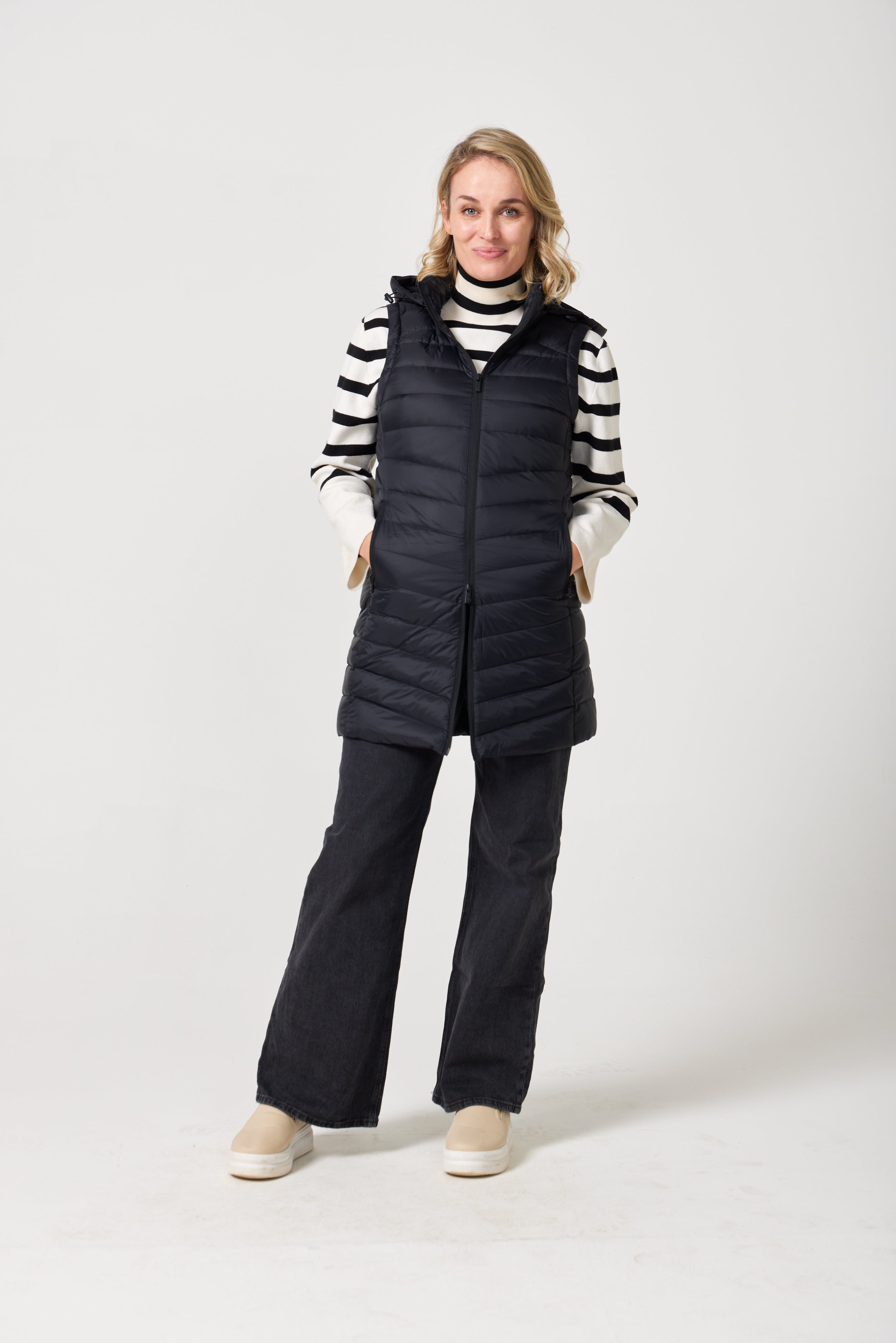 Midnight Longline Gilet™ — women’s sleeveless gilet in black, longline cut with hood, versatile layering piece for winter in South Africa.