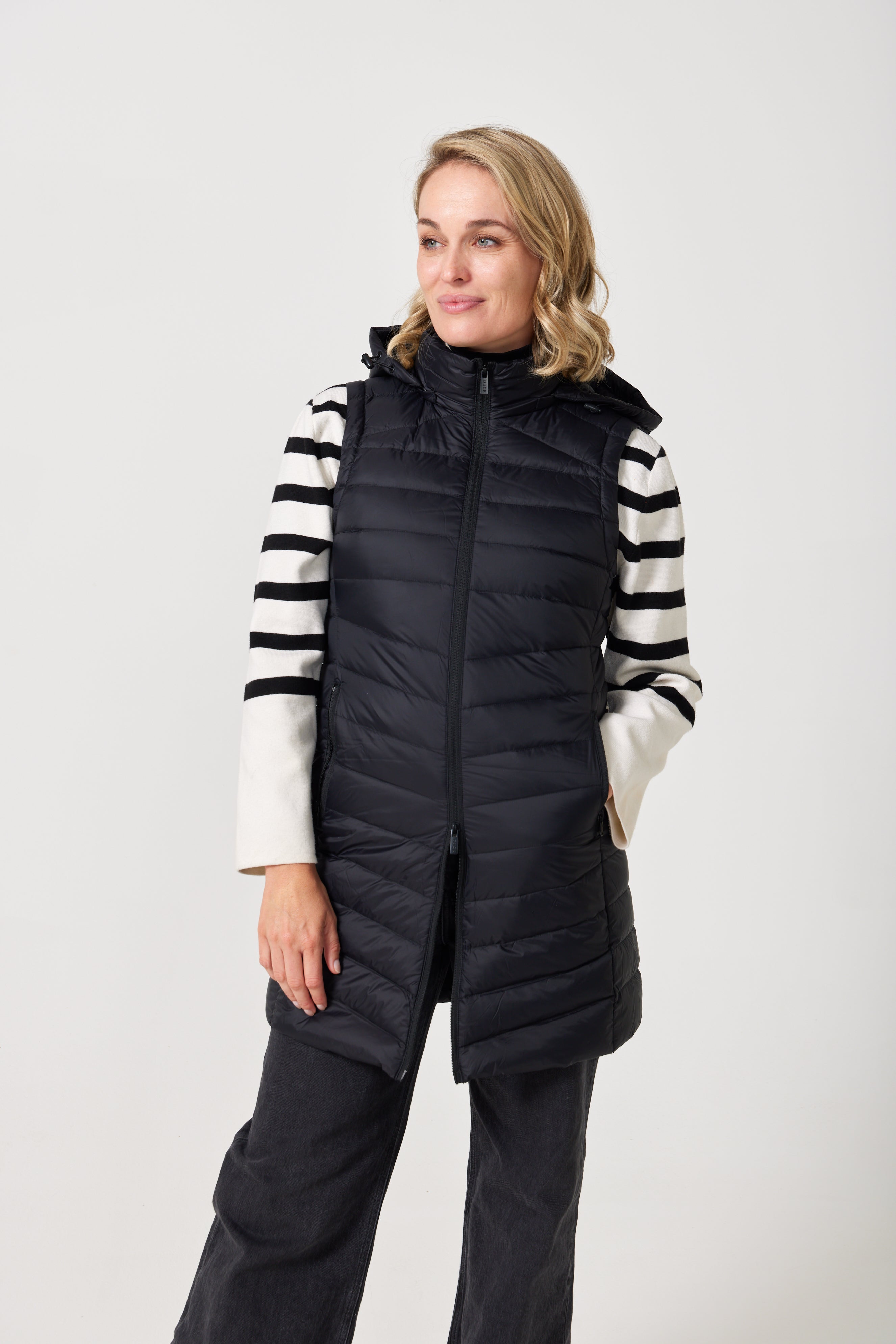 Midnight Longline Gilet™ — women’s sleeveless gilet in black, longline cut with hood, versatile layering piece for winter in South Africa.