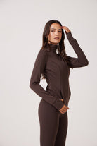 Brown Lightweight performance jacket with a smooth, sculpting fit, full zip front, high collar, and stretch fabric designed for everyday movement and layering.