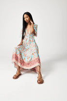 Women’s floral sundress in light blue and pink with a deep V-neck and flowy fit, lightweight summer dress from Duck Apparel South Africa