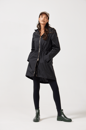 The Highland Midnight raincoat in classic black, lightweight hooded waterproof raincoat ideal for South Africa’s rainy season and wet climate