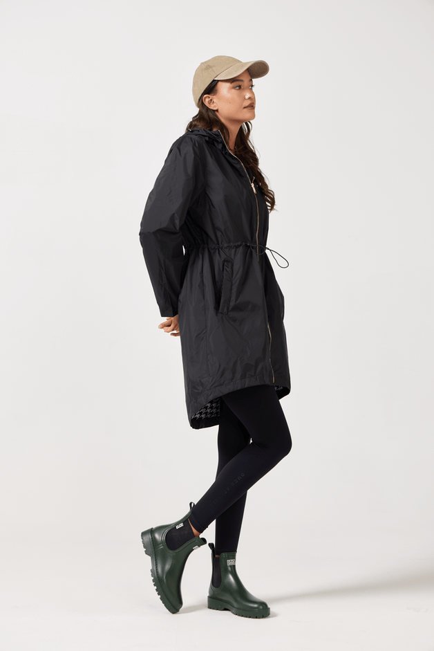 The Highland Midnight raincoat in classic black, lightweight hooded waterproof raincoat ideal for South Africa’s rainy season and wet climate