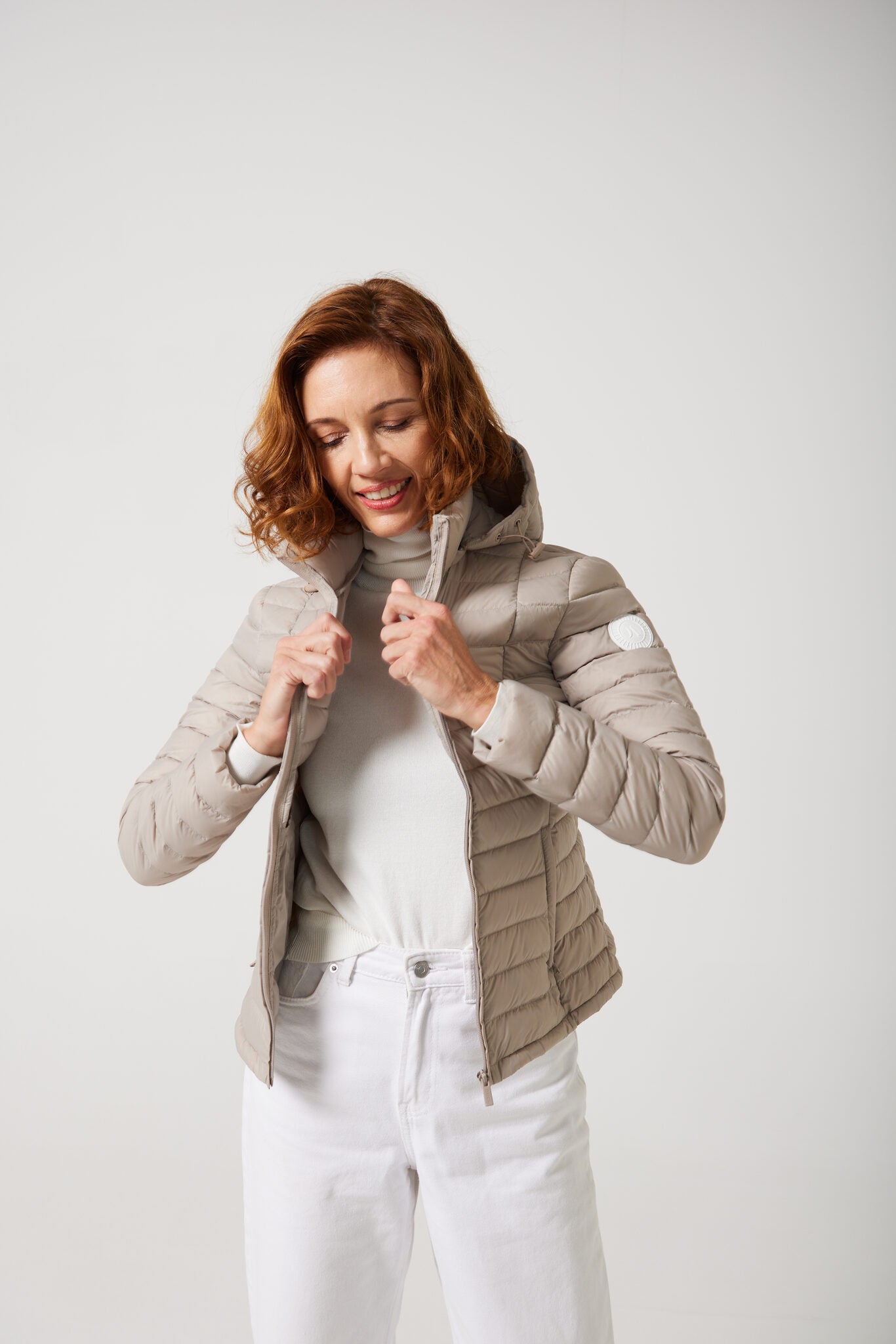 Women’s Latte Classic Jacket™ in a soft beige shade, lightweight puffer jacket with hood, perfect for layering during cool South African weather