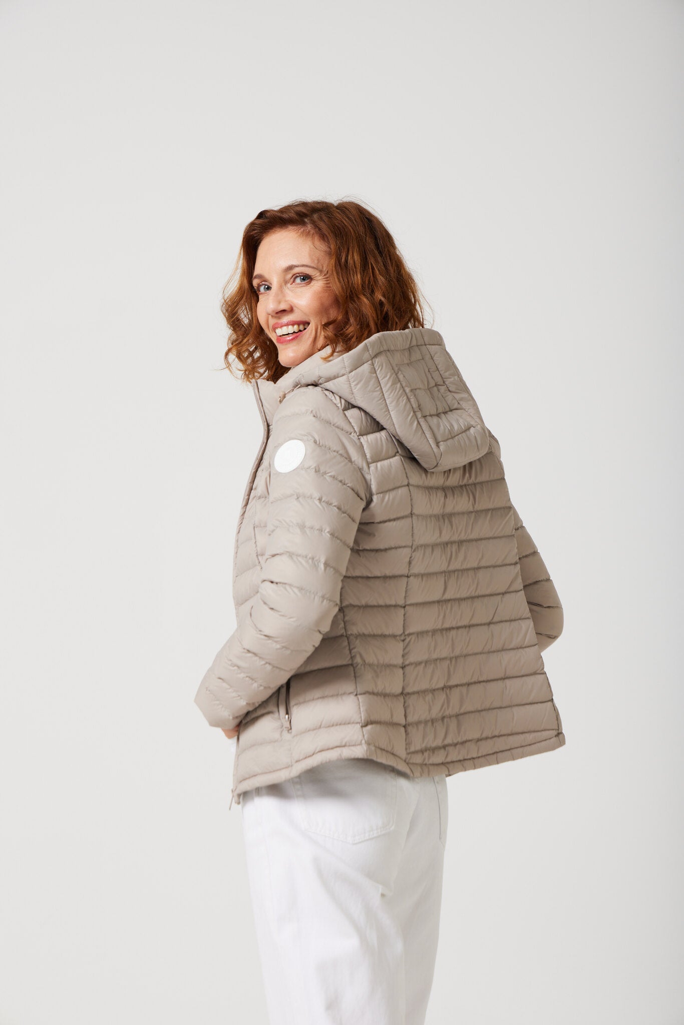 Women’s Latte Classic Jacket™ in a soft beige shade, lightweight puffer jacket with hood, perfect for layering during cool South African weather