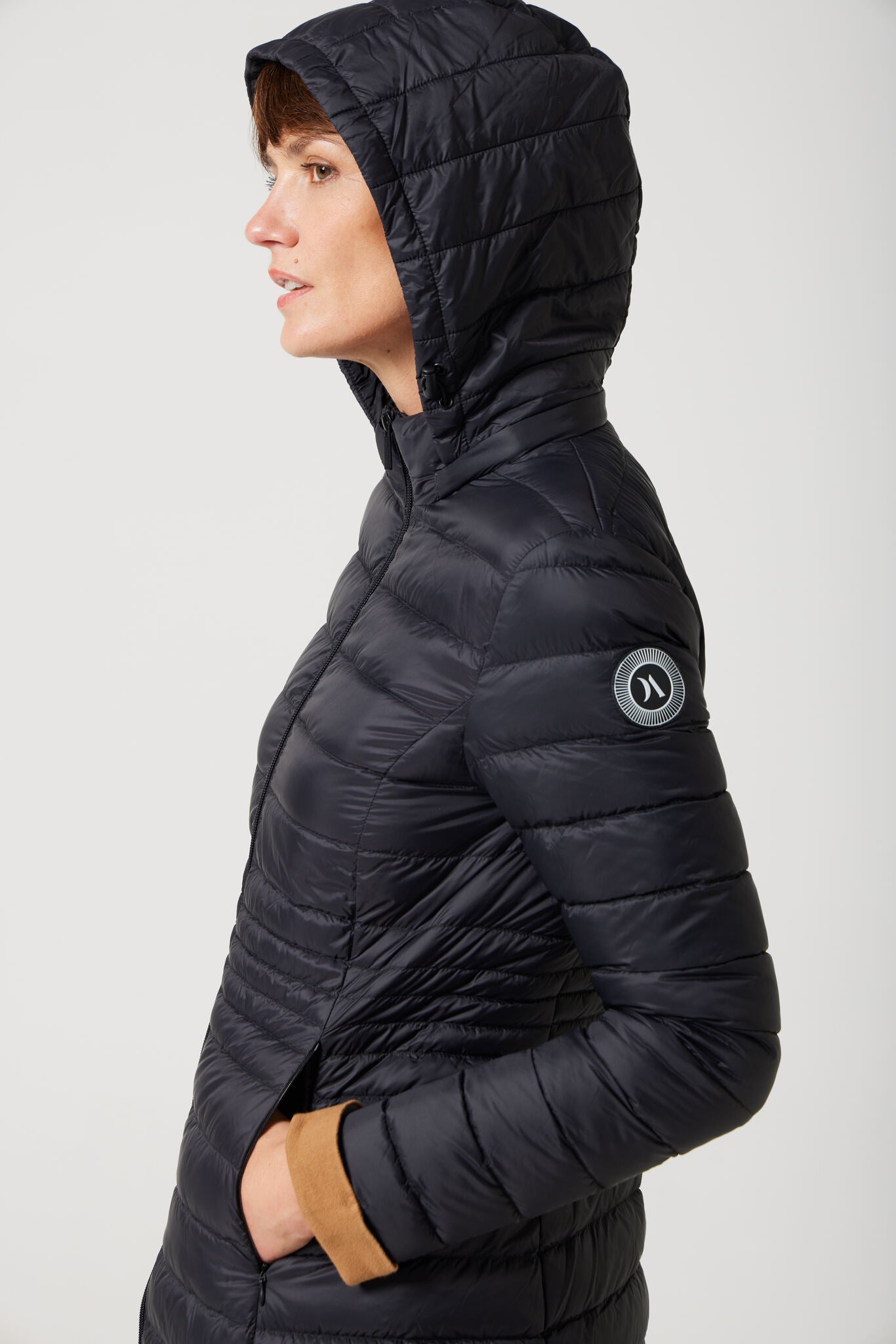 Women’s insulated midi-length hooded parka in midnight black, designed for warmth and comfort in South Africa’s winter season — Midnight Midi Parka™