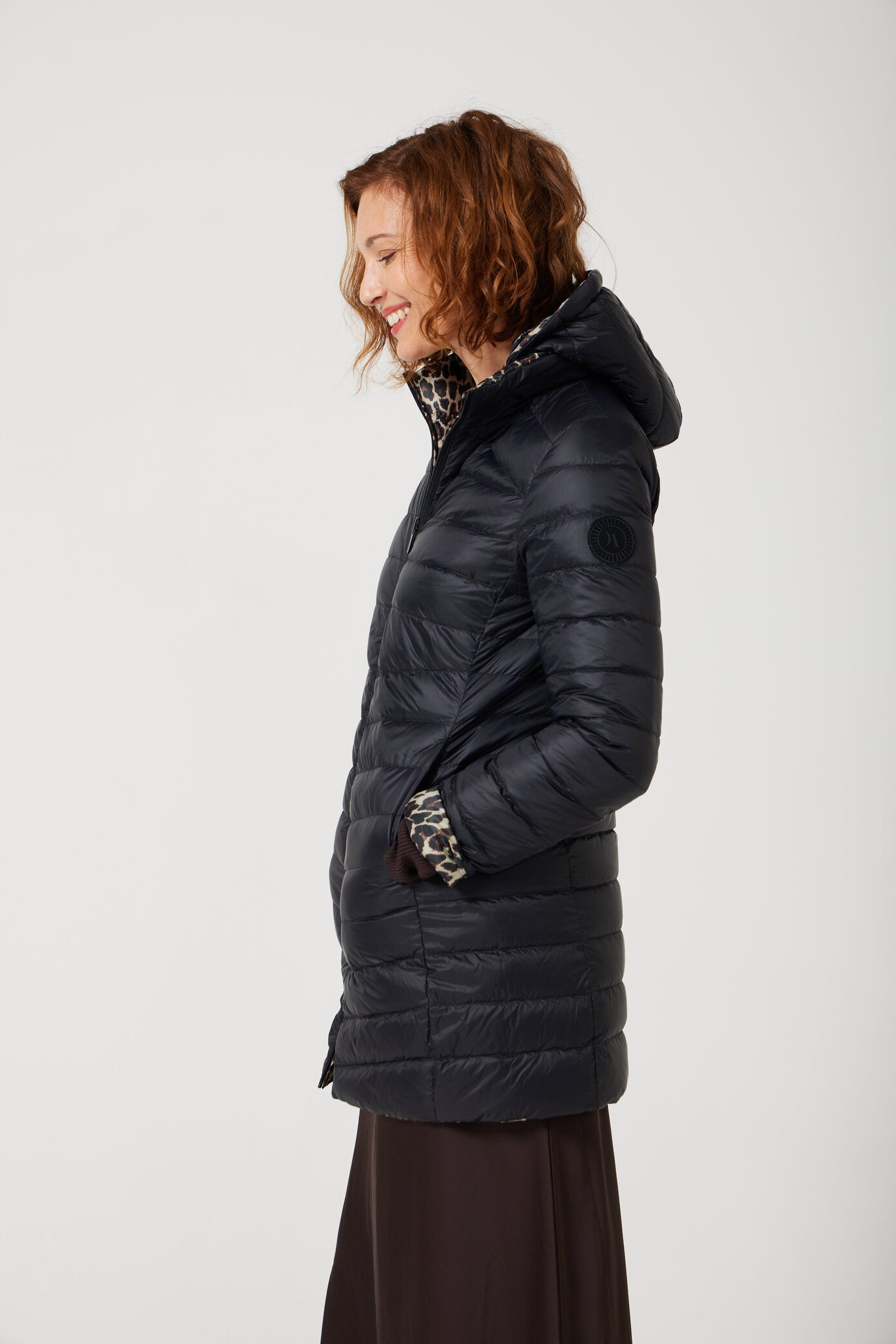 Women’s insulated reversible hooded parka in leopard print and midnight black, designed for warmth and comfort in South Africa’s winter season — Midnight x Leopard Classic Parka™