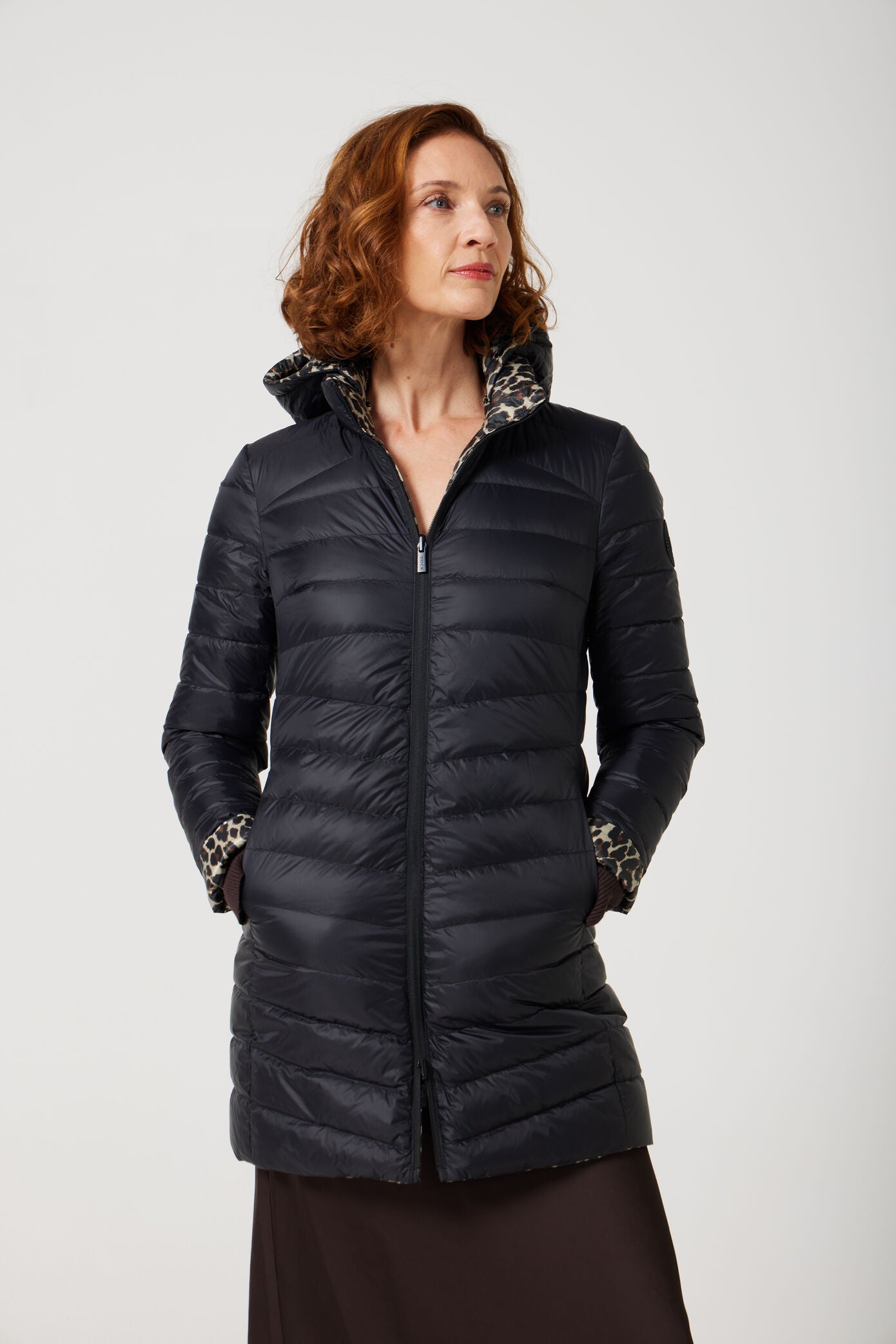 Women’s insulated reversible hooded parka in leopard print and midnight black, designed for warmth and comfort in South Africa’s winter season — Midnight x Leopard Classic Parka™